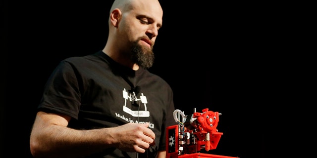 In this photo taken Wednesday, May 15, 2013 Brook Drum, the founder and CEO of Printrbot, displays and talks about his $299 portable 3D printer during the Hardware Innovation Workshop in San Mateo, Calif.
