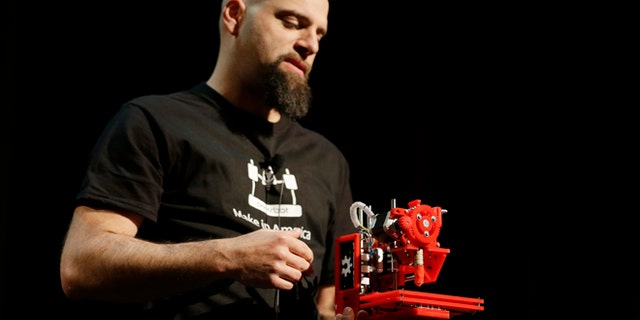 In this photo taken Wednesday, May 15, 2013 Brook Drum, the founder and CEO of Printrbot, displays and talks about his $299 portable 3D printer during the Hardware Innovation Workshop in San Mateo, Calif.
