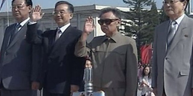 Oct. 4: Chinese Premier Wen Jiabao, second from left, and North Korean leader Kim Jong Il wave to well wishers upon Wen's arrival in Pyongyang.