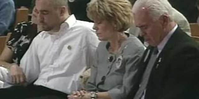 George and Cindy Anthony in their seats after placing a teddy bear at the memorial for their granddaughter Caylee Anthony at First Baptist Orlando in Orlando, Florida.