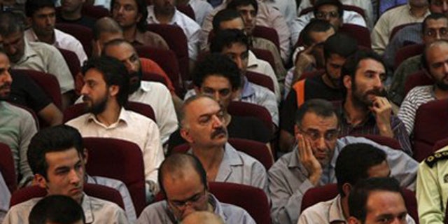 Aug. 1: Defendants sit in a court room in Tehran, Iran.