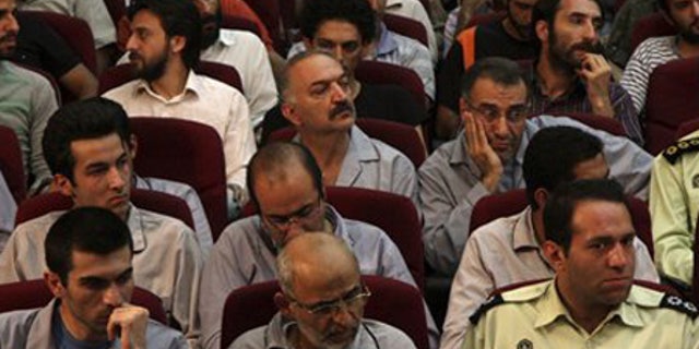 Aug. 1: Defendants sit in a court room in Tehran, Iran.
