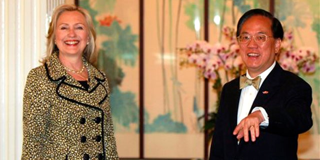 Hong Kong's Chief Executive Donald Tsang, right, greets U.S. Secretary of State Hillary Rodham Clinton at Government House in Hong Kong, China, Monday, July 25, 2011.
