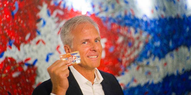 In this June 8, 2016 photo, Stonegate Bank President David Seleski poses with a credit card during an interview in Havana, Cuba. Stonegate, a small Florida bank, will issue the first U.S. credit card designed to work in Cuba on Wednesday, June 15, making it easier for American companies to do business on an island largely cut off from the U.S. financial system. (AP Photo/Ramon Espinosa)