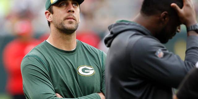 Green Bay Packers quarterback Aaron Rodgers watches teammates warm-up before an NFL football preseason game against the Kansas City Chiefs Thursday, Aug. 28, 2014, in Green Bay, Wis. Rodgers and other starters are not expected to play in the game. (AP Photo/Mike Roemer)