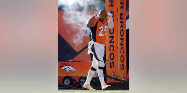 In this Jan. 12, 2014 photo Denver Broncos cornerback Chris Harris Jr. reacts to the crowd as he comes onto the field before playing against the San Diego Chargers in an NFL divisional playoff football game in Denver. A person with knowledge of the results tells The Associated Press that Harris is out for the rest of the playoffs after an MRI on Monday, jan. 13, 2014, revealed a torn ACL in his left knee. (AP Photo/Joe Mahoney)