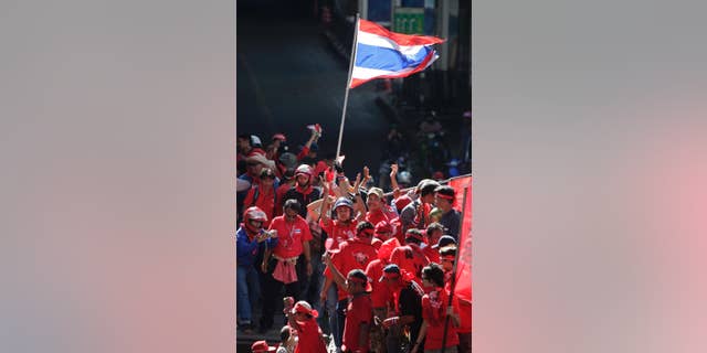 FILE - In this April 12, 2009, file photo, "Red Shirt" demonstrators take to the streets during riots in Bangkok. A Thai court sentenced 15 members of the "Red Shirt" political movement to four years in prison on Thursday, March 5, 2015, for inciting rioting that disrupted an important regional conference in 2009, news reports said. (AP Photo/David Longstreath, File)