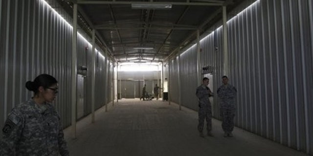 Aug. 27: U.S. soldiers stand outside cells at a newly built U.S.-run Parwan Detention Facility in Bagram north of Kabul, Afghanistan.
