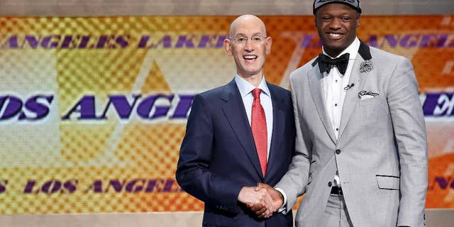 Kentucky forward Julius Randle, right, poses for a photo with NBA commissioner Adam Silver after being selected seventh overall by the Los Angeles Lakers during the 2014 NBA draft, Thursday, June 26, 2014, in New York. (AP Photo/Kathy Willens)