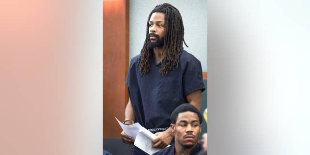 File - In this March 12, 2014 file photo, Kirk Bills stands in court at the Regional Justice Center in Las Vegas. Bills, a one-time boxer who’s been jailed for more than a year, is due to learn how much prison time he’ll serve for setting a fire in a pet shop in January 2014 at sentencing on Monday, March 2, 2015, in Clark County District Court. (AP Photo/Las Vegas Sun, Steve Marcus, file)