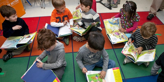 Students in pre-kindergarten read a book by Alan Katz during OfficeMax's "A Day Made Better" presentation at Hurlbutt Elementary School on April 26, 2010, in Weston, Connecticut.