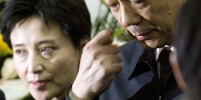 FILE - In this Jan. 17, 2007 file photo, former Chongqing Communist Party Secretary Bo Xilai, right, accompanied by his wife Gu Kailai, attends a funeral for his father in Beijing.