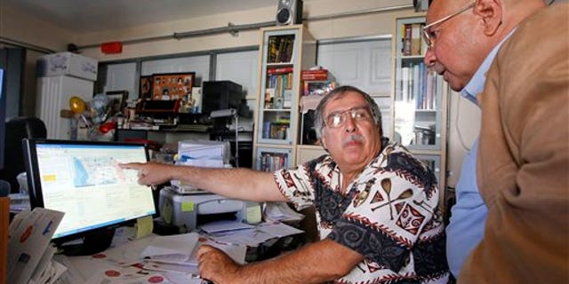 In this June 15, 2011 photo, Art Montez, left, and Reben Treviso look at potential congressional redistricting maps on Montez's home computer, in Buena Park, Calif. The debate over redistricting proposals by the independent commission will escalate in the coming weeks, as the panel takes public comment and wrestles with revisions before voting on a final version Aug. 15. (AP Photo/Chris Carlson)