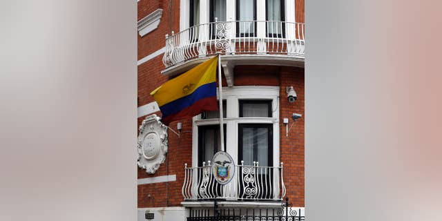 The Ecuadorian flag flies outside the Ecuadorian Embassy in London, where Julian Assange is fighting new restrictions on his activities. (AP Photo/Kirsty Wigglesworth)