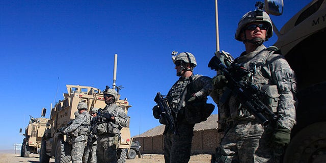 Nov. 19: U.S. Army soldiers stand next to their vehicles at a checkpoint near the town of Balisal Afghan, Afghanistan. (AP)
