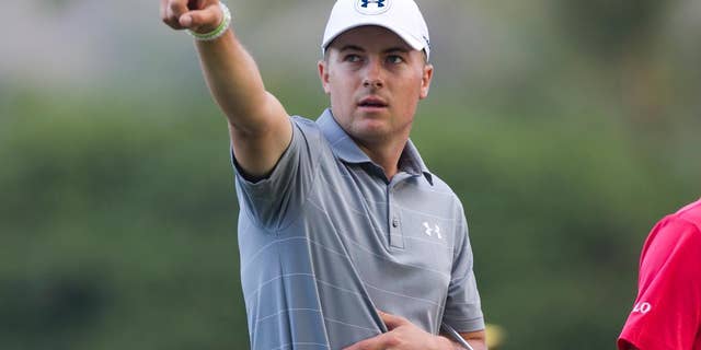 While walking on the 11th fairway with playing partner Justin Thomas (not pictured), Jordan Spieth points to something off the course during the first round of the Sony Open golf tournament, Thursday, Jan. 12, 2017, in Honolulu. (AP Photo/Marco Garcia)