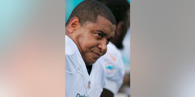 FILE - In this Oct. 27, 2013 file photo, Miami Dolphins tackle Jonathan Martin sits on the bench in the first quarter of an NFL football game against the New England Patriots, in Foxborough, Mass. A person familiar with the situation said Thursday, Oct. 31, 2013, that Martin has left the team to receive professional assistance for emotional issues. The person spoke to The Associated Press on condition of anonymity because the Dolphins have not announced any details of Martin's illness. (AP Photo/Michael Dwyer, File))