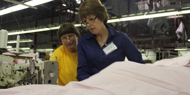 Rep. Gwen Graham, D-Fla., works on the factory floor during a "workday."