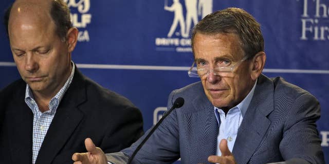 PGA Tour Commissioner Tim Finchem, right, gestures during a golf industry news conference at The Players Championship golf tournament Wednesday, May 6, 2015, in Ponte Vedra Beach, Fla. Looking on is Mike Davis, Executive Director of the USGA. (AP Photo/Chris O'Meara)