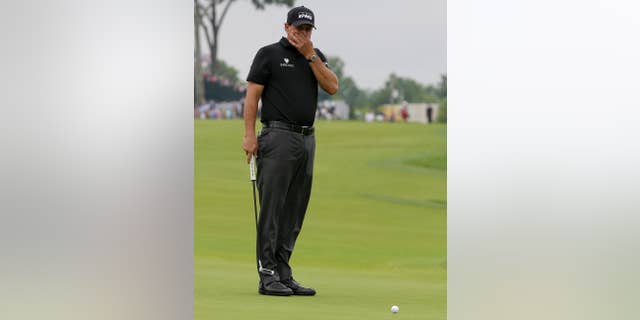 Phil Mickelson watches his putt on the 10th hole during the rain delayed first round of the U.S. Open golf championship at Oakmont Country Club on Friday, June 17, 2016, in Oakmont, Pa. (AP Photo/Gene J. Puskar)