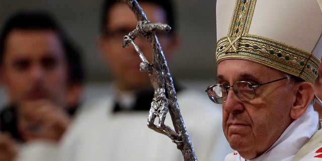 Pope Francis arrives to celebrate a mass where he will ordain ten new priests in St. Peter's Basilica at the Vatican, Sunday, April 21, 2013. (AP Photo/Gregorio Borgia)