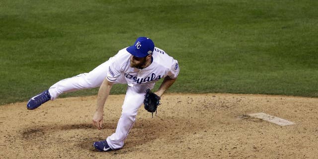 Kansas City Royals pitcher Greg Holland throws during the ninth inning of Game 7 of baseball's World Series against the San Francisco Giants Wednesday, Oct. 29, 2014, in Kansas City, Mo. (AP Photo/Jeff Roberson)