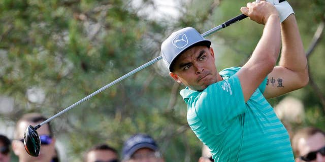 Rickie Fowler watches his tee shot on the 11th hole during the first round of the Memorial golf tournament, Thursday, June 2, 2016, in Dublin, Ohio. (AP Photo/Darron Cummings)