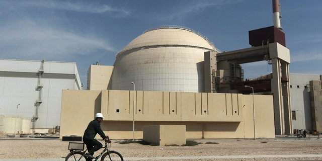 FILE - In this Oct. 26, 2010 file photo, a worker rides a bicycle in front of the reactor building of the Bushehr nuclear power plant, just outside the southern city of Bushehr, Iran. Israel has led the speculation that Iran could be moving closer to having all the pieces ready for a nuclear weapon. Israel also fears the negotiations could leave intact the mainstays of Iran's nuclear network: The ability to enrich uranium and produce atomic fuel. (AP Photo/Mehr News Agency, Majid Asgaripour, File)