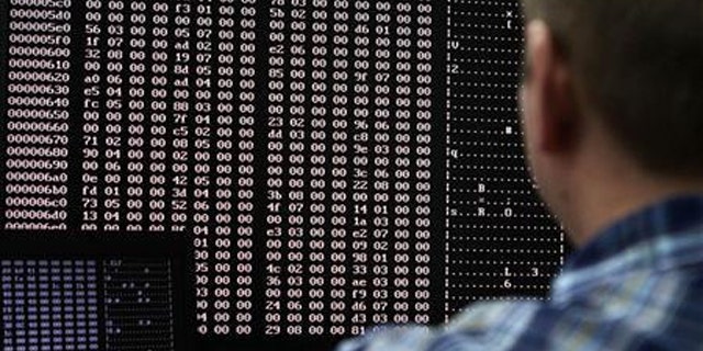 An analyst looks at code in the malware lab of a cyber security defense lab at the Idaho National Laboratory in Idaho Falls, Idaho.
