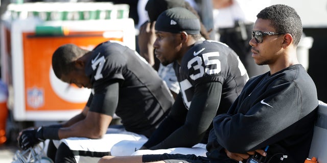 Oakland Raiders quarterback Terrelle Pryor, right, defensive back Chimdi Chekwa (35), and punter Marquette King (7) sit on the bench during the fourth quarter of the Raiders' 24-14 loss to the Washington Redskins in an NFL football game Sunday, Sept. 29, 2013, in Oakland, Calif. (AP Photo/Marcio Jose Sanchez)
