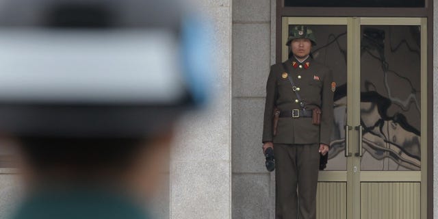 PANMUNJOM, SOUTH KOREA - APRIL 23: A North Korean soldier looks at South Korea across the Korean Demilitarized Zone (DMZ), on April 23, 2013 in Panmunjom, South Korea. The tension at Korean Peninsula remains high as North Korea's ballistic missiles have been ready to launch ahead of North Korean Army foundation celebration day on April 25. (Photo by Chung Sung-Jun/Getty Images)