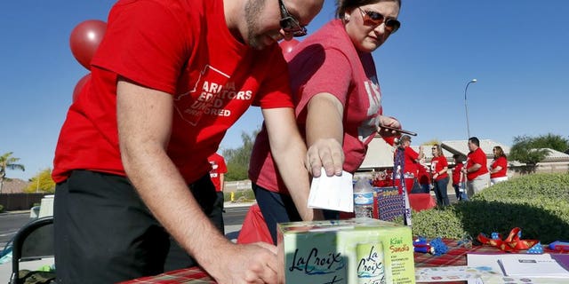 In this April 18, 2018 photo, two Arizona teachers cast their ballots outside Paseo Verde Elementary. Arizona teachers Thursday to walk out of their classrooms to demand more school funding after weeks of growing protests.