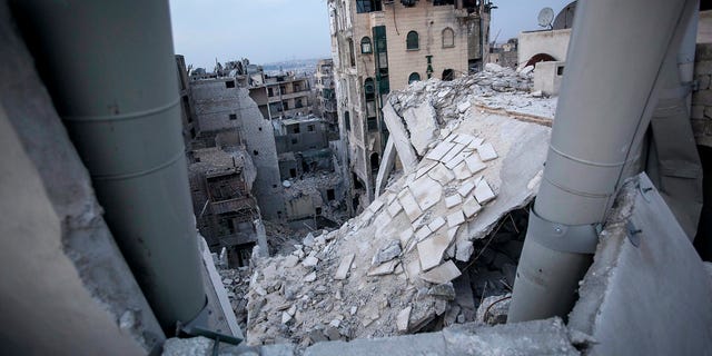 FILE - In this Thursday, Nov. 29, 2012 file photo, destroyed buildings, including the Dar Al-Shifa hospital, bottom, lay in ruins following airstrikes in Aleppo, Syria, in this file photo dated Thursday, Nov. 29, 2012. In the summer of 2012 fighting spread to the former commercial capital, Syria's largest city Aleppo, with rebel forces controlling some neighborhoods, but the battle for overall control continues to this day and much of the city lays in ruins. (AP Photo/Narciso Contreras, File)