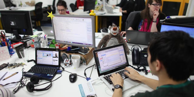 LONDON, ENGLAND - MARCH 15: People work at computers in TechHub, an office space for technology start-up entrepreneurs, near the Old Street roundabout in Shoreditch which has been dubbed 'Silicon Roundabout' due to the number of technology companies operating from the area on March 15, 2011 in London, England. Entrepreneurs using TechHub are predominantly product-oriented tech companies who rent desk space and use the fast wifi. The relatively low rental rates and proximity to media and internet companies has made the area close to the roundabout a prime location for IT firms and web entrepreneurs. (Photo by Oli Scarff/Getty Images)