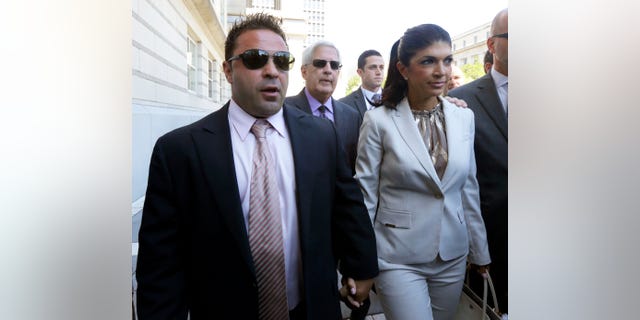 FILE - In this July 30, 2013 file photo, “The Real Housewives of New Jersey” stars Giuseppe "Joe" Giudice, left, and his wife, Teresa Giudice, of Montville Township, N.J., walk out of Martin Luther King Jr. Courthouse after an appearance in Newark, N.J. The Giudices are facing additional fraud charges as they were each indicted Monday, Nov. 18, 2013, on one count of bank fraud and one count of loan application fraud. Monday's charges are in addition to a 39-count indictment handed down in July, charging the couple with conspiracy to commit mail and wire fraud, bank fraud, making false statements on loan applications and bankruptcy fraud. (AP Photo/Julio Cortez, File)