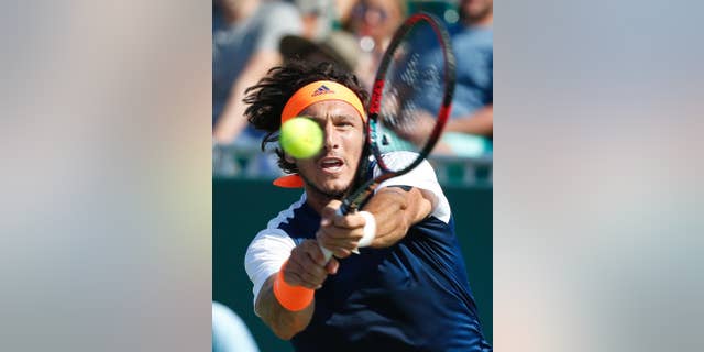 File.- In this March 22, 2017 file photo Juan Monaco returns a shot from Federico Delbonis, both of Argentina, during a tennis match at the Miami Open in Key Biscayne, Fla. Monaco, 33, announced Monday May 15 his retirement from competition.(AP Photo/Wilfredo Lee, File)