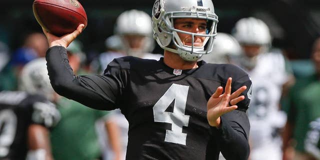 Oakland Raiders quarterback Derek Carr (4) throws a pass during the first half of an NFL football game against the New York Jets Sunday, Sept. 7, 2014, in East Rutherford, N.J. (AP Photo/Seth Wenig)