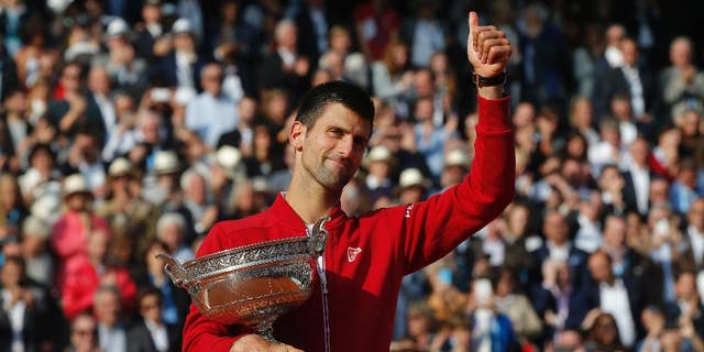 FILE - In this Sunday, June 5, 2016 file photo, Serbia's Novak Djokovic holds the trophy after winning the final of the French Open tennis tournament against Britain's Andy Murray, at the Roland Garros stadium in Paris, France. Novak Djokovic on Friday, Sept. 30 says Grand Slam trophies and the No. 1 ranking are no longer his priority. The top-ranked Serb, who has won 12 major titles, says he felt emotionally drained after winning the French Open in June for his first Grand Slam title at Roland Garros and his fourth in a row. (AP Photo/Michel Euler, file)