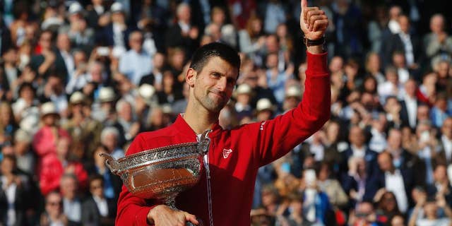 FILE - In this Sunday, June 5, 2016 file photo, Serbia's Novak Djokovic holds the trophy after winning the final of the French Open tennis tournament against Britain's Andy Murray, at the Roland Garros stadium in Paris, France. Novak Djokovic on Friday, Sept. 30 says Grand Slam trophies and the No. 1 ranking are no longer his priority. The top-ranked Serb, who has won 12 major titles, says he felt emotionally drained after winning the French Open in June for his first Grand Slam title at Roland Garros and his fourth in a row. (AP Photo/Michel Euler, file)