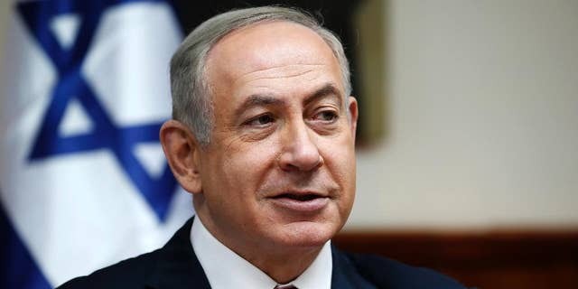 FILE - In this Sunday, Jan. 22, 2017, file photo, Israeli Prime Minister Benjamin Netanyahu attends the weekly cabinet meeting in Jerusalem. An Israeli newspaper quoted President Donald Trump on Friday, Feb. 10, as saying that settlement expansion in land claimed by the Palestinians does not advance peace indicating there might be some difficult discussions on the topic at the heart of the conflict in a high profile White House meeting with Netanyahu next week. (Ronen Zvulun/Pool Photo via AP, File)