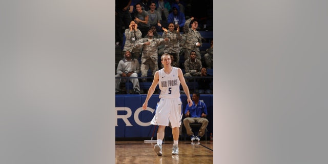 Fans celebrate behind Air Force's Mike Fitzgerald after his three-point basket in the second half of an NCAA college basketball game Nevada at Clune Arena in Air Force Academy, Colo., Wednesday, Jan. 9, 2013. Air Force went on to win 78-65 and Fitzgerald had 30 points for the day. (AP Photo/ The Gazette, Mark Reis) MAGAZINES OUT