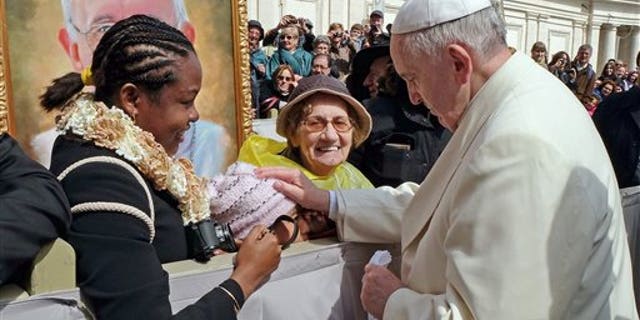 Pope Francis touches 10-year-old Jersey Vargas on March 26, 2014.