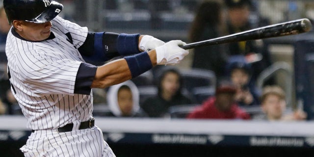 New York Yankees' Alex Rodriguez follows through on a home run during the sixth inning of a baseball game against the Toronto Blue Jays on Thursday, April 9, 2015, in New York. (AP Photo/Frank Franklin II)
