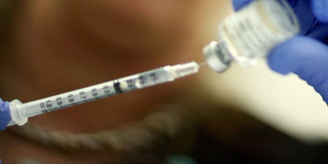 MIAMI - NOVEMBER 03: Marina Spelzini, a registered nurse, measures out an H1N1 vaccine shot at the Miami Dade County Health Department downtown clinic on November 3, 2009 in Miami, Florida. Unlike other parts of the country which are experiencing long lines and shortages of the vaccine, South Florida is not having this problem. The Miami-Dade County Health Department received 195,000 doses of the vaccine but has only given out about 10,100. Broward County has 52,000 doses on hand and has administered about 10,000 doses. (Photo by Joe Raedle/Getty Images)