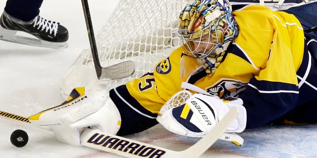 Nashville Predators goalie Pekka Rinne, of Finland, blocks a shot against the New York Islanders in the first period of an NHL hockey game on Saturday, Oct. 12, 2013, in Nashville, Tenn. (AP Photo/Mark Humphrey)