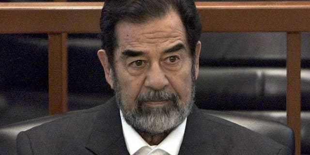 FILE - In this Dec. 6, 2006 file photo, former Iraq leader Saddam Hussein sits in court in Baghdad, Iraq, during the "Anfal" trial against him. Republican Donald Trump is again praising the former Iraqi President Hussein's ruthlessness, saying he killed terrorists "so good." Trump was speaking at a rally Tuesday, July 5, 2016, in North Carolina when he turned to the former Iraqi leader. (AP Photo/Chris Hondros, Pool, File)