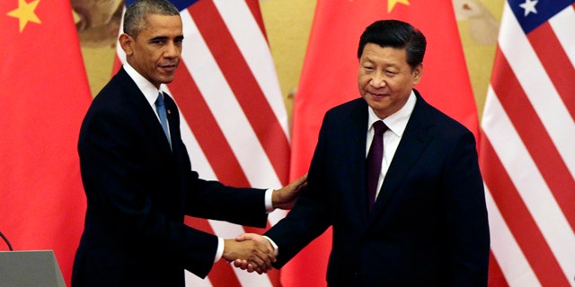 November 12, 2014: U.S. President Barack Obama, left, shakes hands with Chinese President Xi Jinping after their press conference at the Great Hall of the People in Beijing. (AP Photo/Andy Wong)