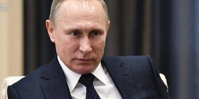 Russian President Vladimir Putin listens during a meeting in Moscow, Russia, Monday, Feb. 6, 2017. The Kremlin is indignant over the comments of a Fox News journalist who called Russian President Vladimir Putin a "killer" in an interview with President Donald Trump. (Alexei Nikolsky, Sputnik, Kremlin Pool Photo via AP)