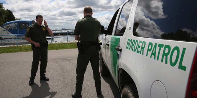 BEAVER ISLAND STATE PARK, NY - JUNE 03: U.S. Border Patrol agents talk while at a marina on the Niagara River at the U.S.-Canada border on June 3, 2013 in Beaver Island State Park, New York. U.S. Customs and Border Protection, which includes the Border Patrol, monitors the 5,525 mile long border, including Alaska, forming the longest international border between two countries in the world. (Photo by John Moore/Getty Images)