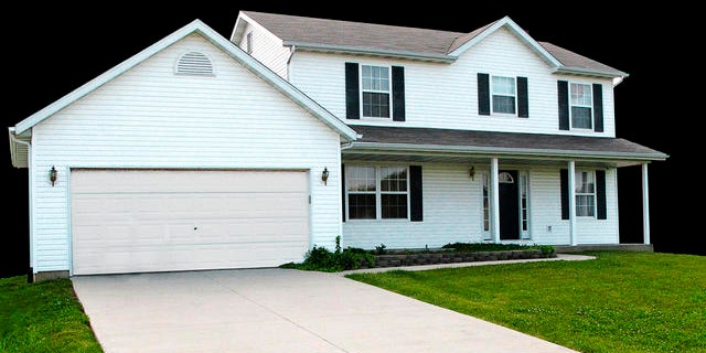 In this photo taken Monday, May 24, 2010, a two-story house where a mother and her two young sons were found strangled a year ago sits vacant in Columbia, Ill. A foreclosure sale is planned Tuesday afternoon May 25, 2010 in Monroe County for the Columbia home where Sheri Coleman and her sons were killed. By Illinois law, the house must be sold "as is", meaning prospective buyers don't get a chance to inspect it. (AP Photo/Jim Suhr)